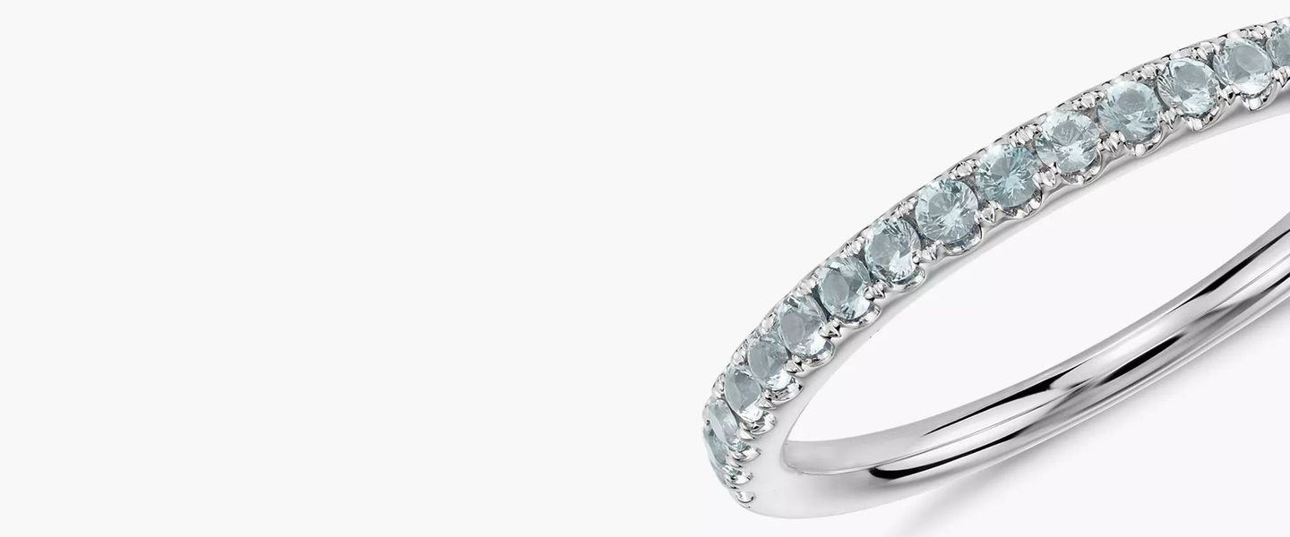 A March birthstone eternity band of round brilliant-cut aquamarines pavé-set in white gold