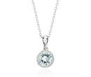 A March birthstone pendant necklace of a round aquamarine gemstone framed in sterling silver and detailed with sterling silver rope motif