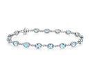 A birthstone bracelet of oval-cut aquamarine gemstones separated by small infinity shaped links of white gold