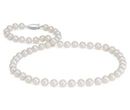 A strand of nearly round white freshwater pearls of 8 millimeters with white gold clasp