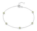 A birthstone bracelet of stationed bezel-set peridot gemstones across a white gold cable chain