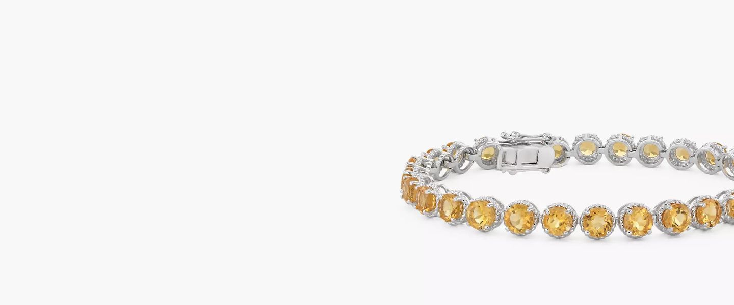 A November birthstone bracelet of twenty-eight round citrine gemstones rimmed in sterling silver miglrain halos