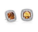 A pair of birthstone stud earrings of cushion-cut citrines are surrounded by a halo of white topaz and accented with a rope design of sterling silver