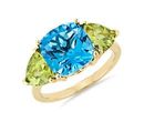 An December birthstone engagement ring of cushion-cut swiss blue topaz center framed by two trillion-cut peridot stones set in yellow gold