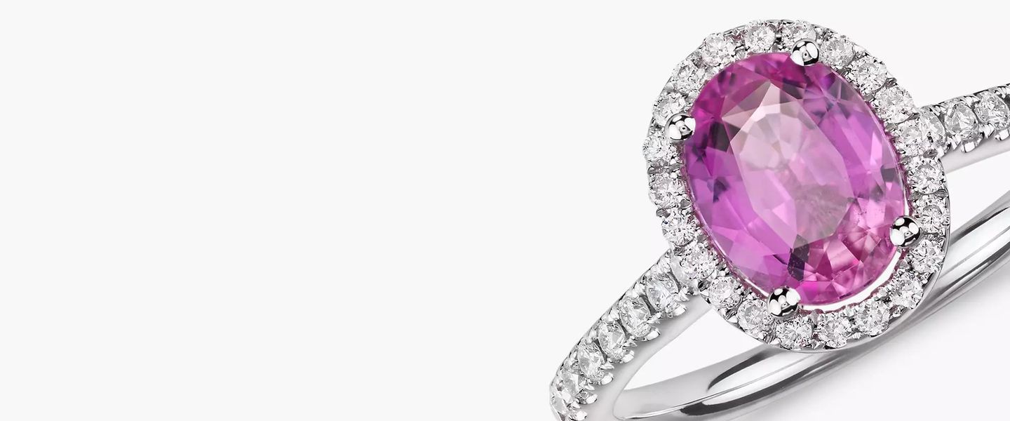 A pink sapphire and pave diamond engagement ring in white gold