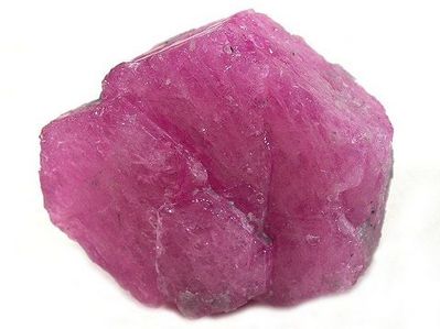 A pink sapphire gemstone in unpolished crystal form