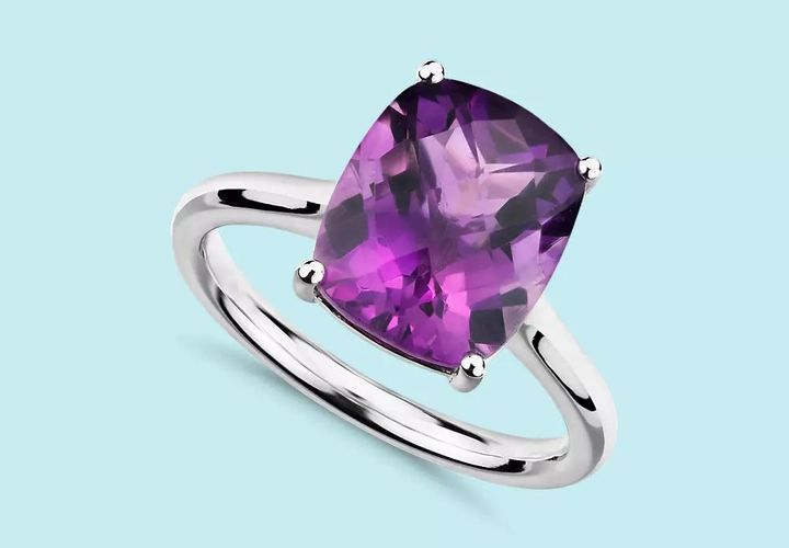 A large cushion cut amethyst engagement ring in a white gold setting