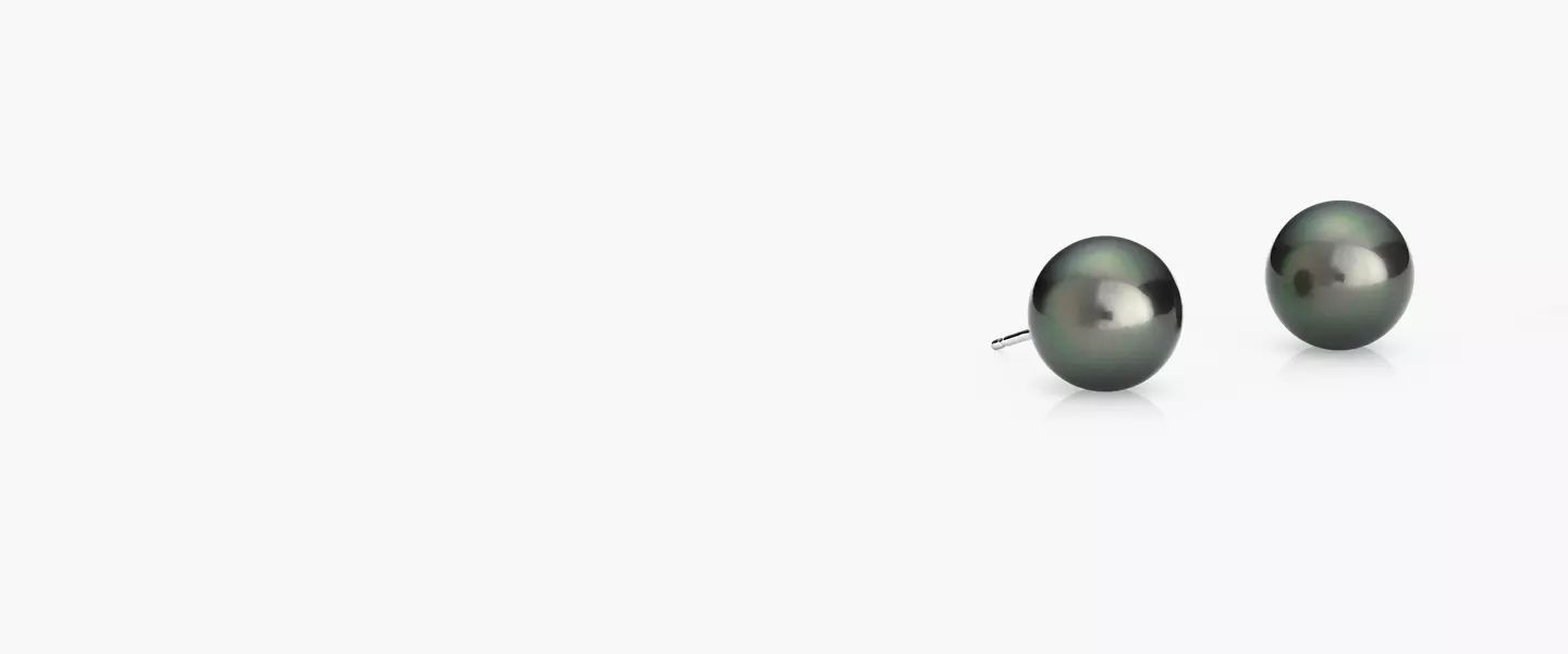 A pair of 10 millimeter black with green undertone Tahitian cultured pearl stud earrings with white gold posts