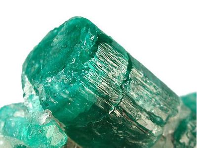 An emerald gemstone in unpolished crystal form
