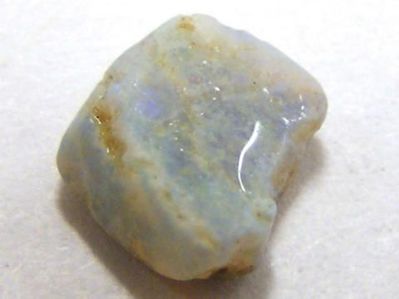 A milky opal gemstone in unpolished crystal form