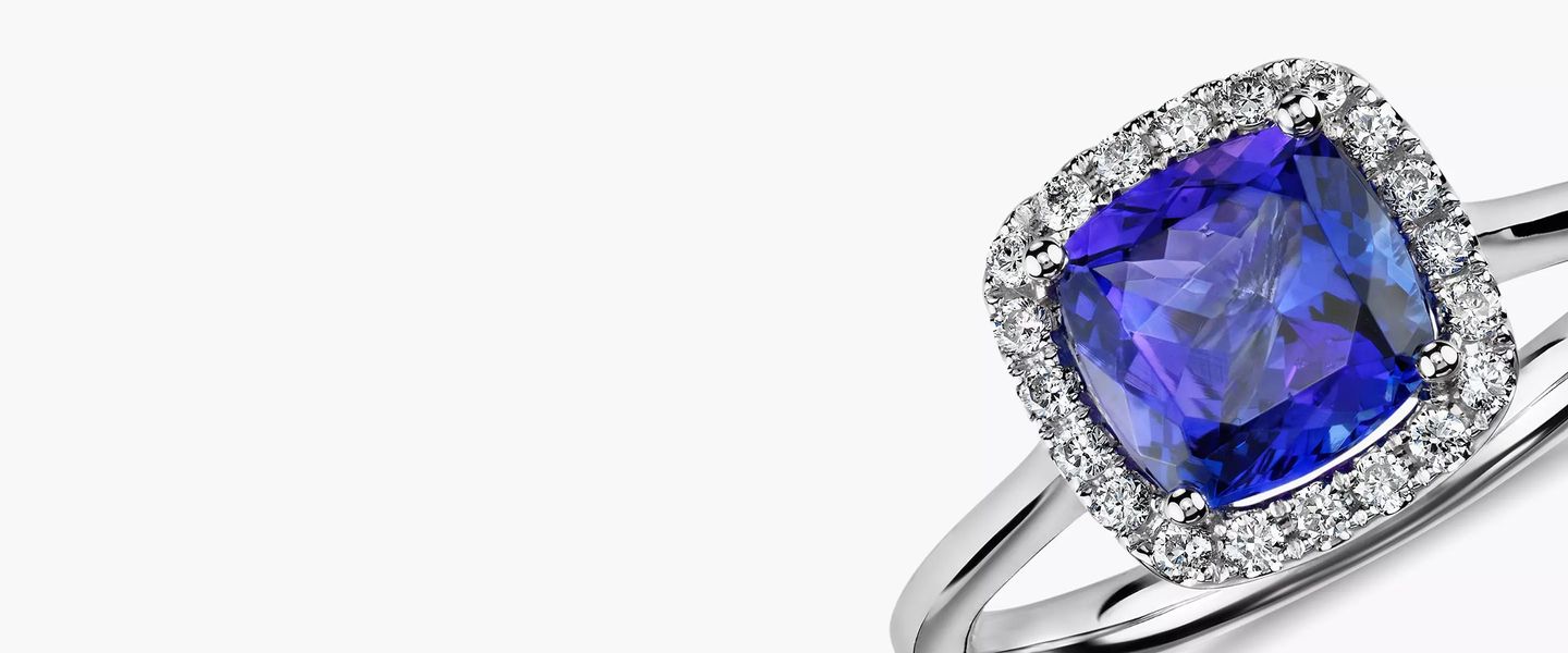 A square tanzanite engagement ring with diamond pave halo setin white gold
