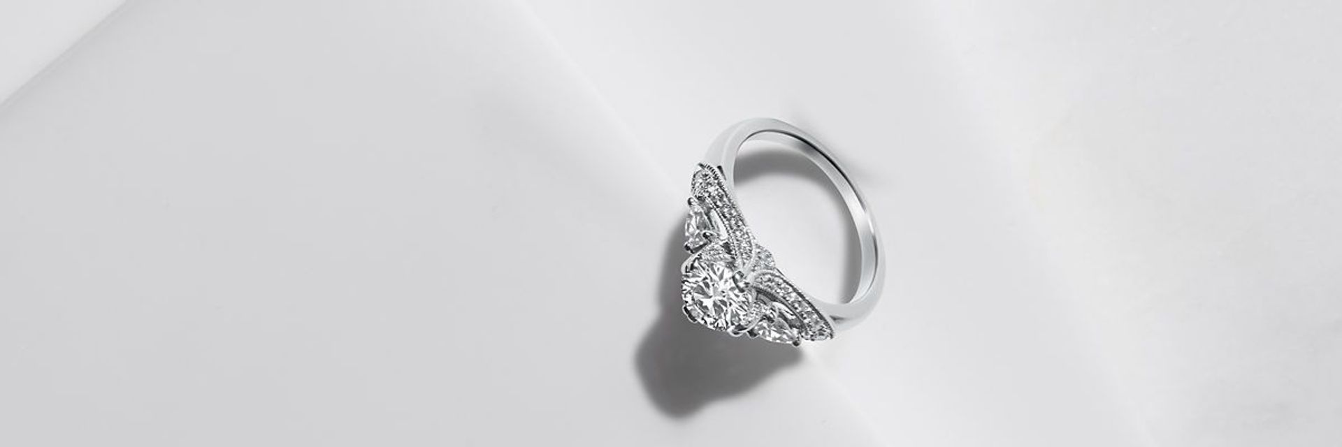 ZAC Zac Posen deco-inspired 14k white gold engagement ring featuring a round center diamond and 2 pear-shaped side stones.
