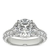 Triple row diamond Bella Vaughan engagement ring, featuring a round center diamond flanked by two trapezoid side stones.