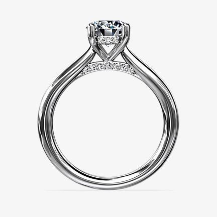 White gold hidden halo engagement ring featuring diamonds at the head of the ring