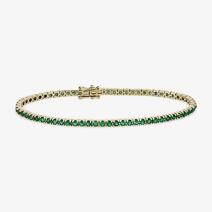 14k yellow gold emerald bracelet in a tennis style.  
