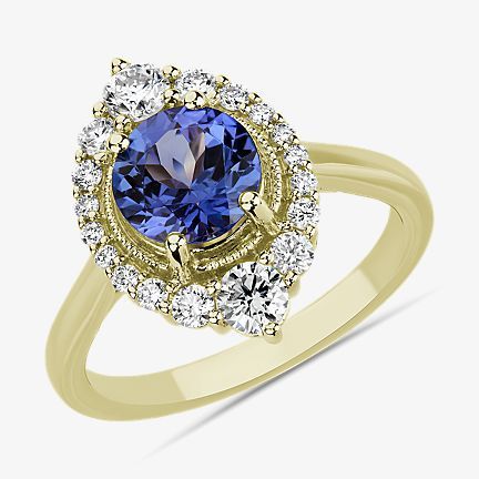Statement ring featuring tanzanite and diamond halo in yellow gold