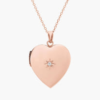 Rose gold heart-shaped locket with diamond star detail on a chain.