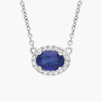 Elegant sapphire necklace with diamond halo and silver chain.