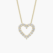 Gold necklace with a heart-shaped diamond pendant.