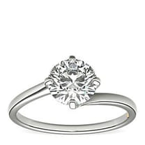 Solitaire diamond engagement ring on a white background.
