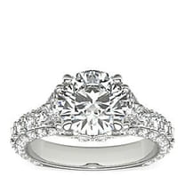 Elegant diamond ring with a round center stone and sparkling band.