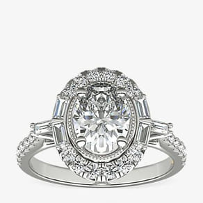 Elegant diamond ring with an oval center surrounded by smaller diamonds.