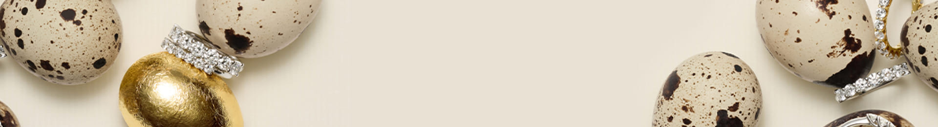 Quail eggs with diamond rings on a light background