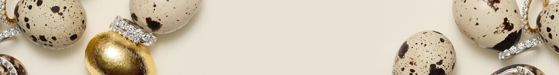 Quail eggs with diamond rings on a light background