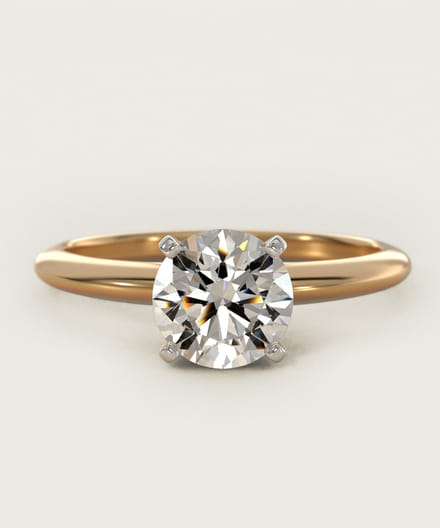 Gold engagement ring with a large round-cut diamond in a classic solitaire setting.