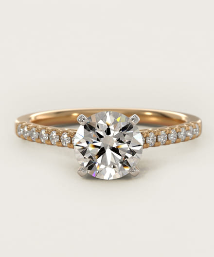 Gold band ring with a large diamond and smaller diamonds on the band.