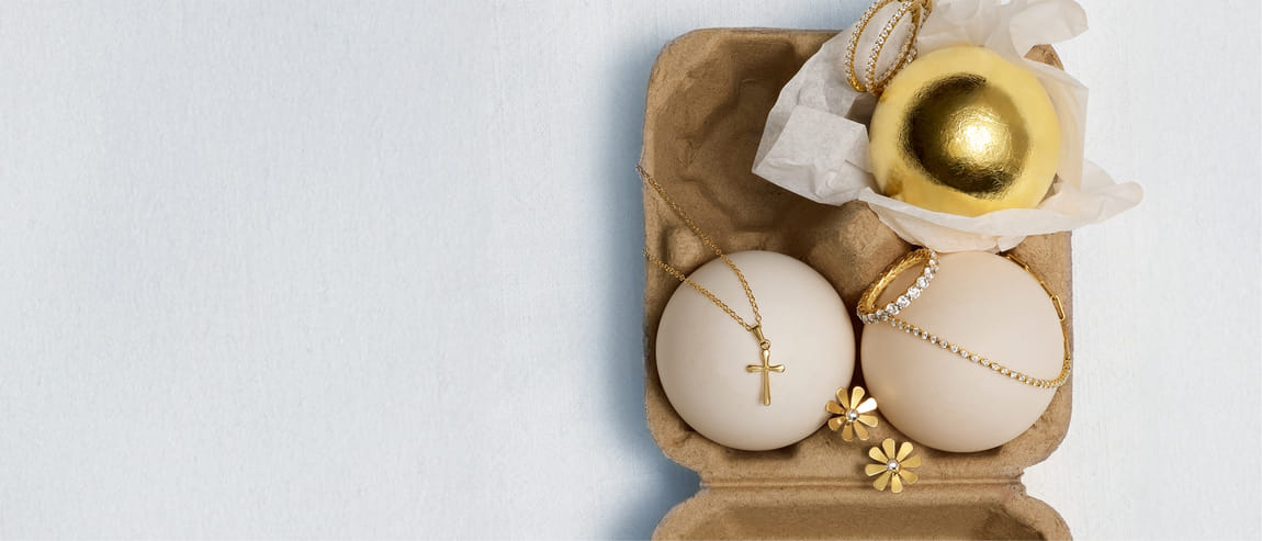 Gold eggs paired with diamond rings on a light background.