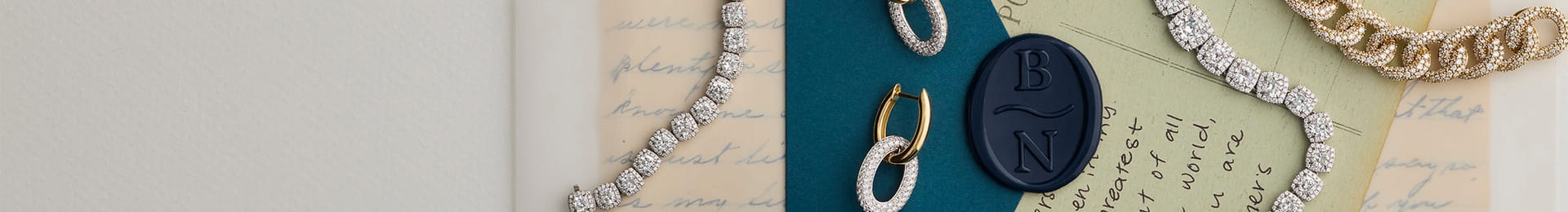 Elegant jewelry pieces arranged on handwritten letters with a wax seal.