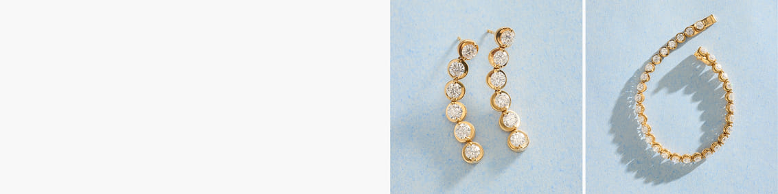 Gold and diamond earrings and bracelet set on a light blue background.