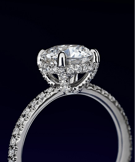 Elegant diamond ring with a large central stone and smaller stones on the band.