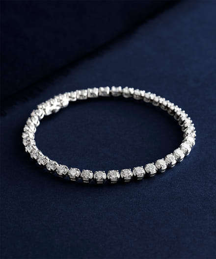Elegant diamond tennis bracelet on a dark blue background