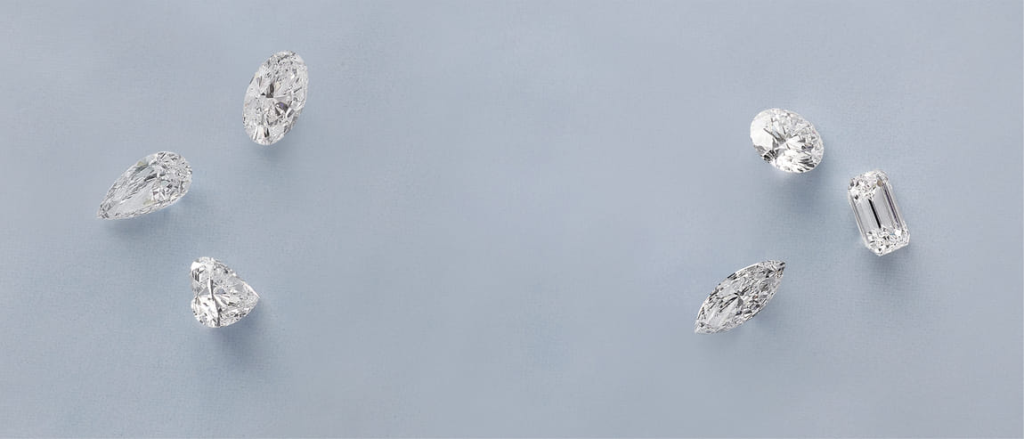Various sparkling diamonds displayed on a light blue background.