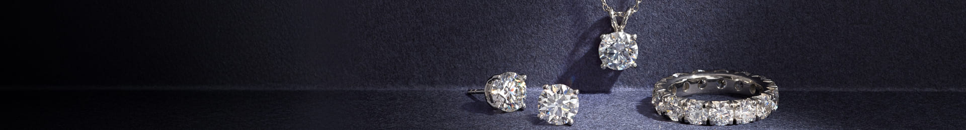 Various diamond jewelry pieces beautifully arranged on different backgrounds.